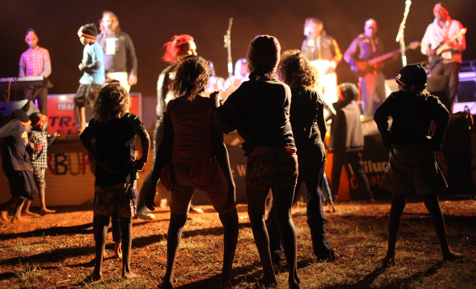 The Warburton community dancing to support act, Running Water, at the 2014 Sand Tracks tour. The 2016 tour, headlined by the legendary Lajamanu Teenage Band and supported by Desert Hip Hop, will once again visit the town of Warburton, and 5 other communities in the central desert region.