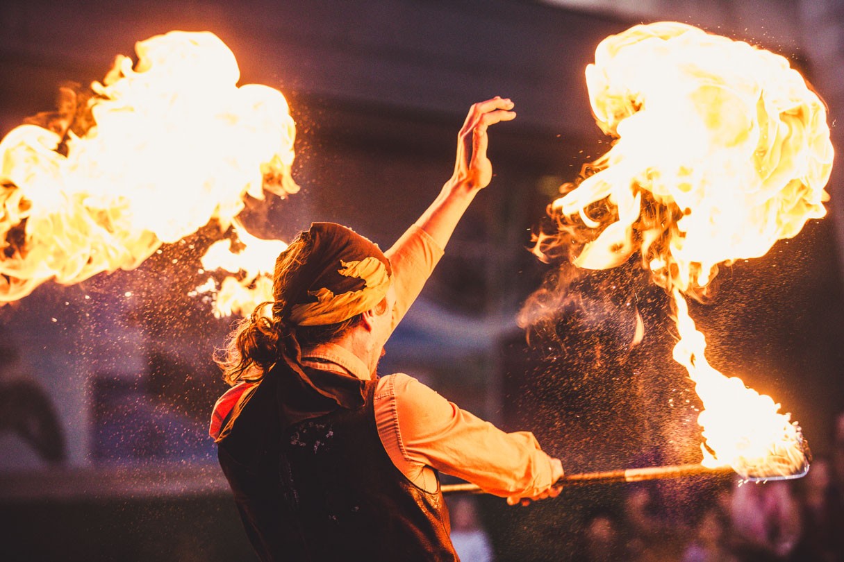 Pyro artist plays with fire sticks.