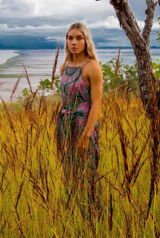 Model standing in tall grass