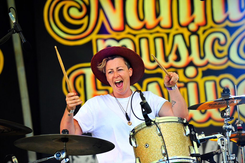 Drummer holds drum sticks in the air, from the band This Way North.