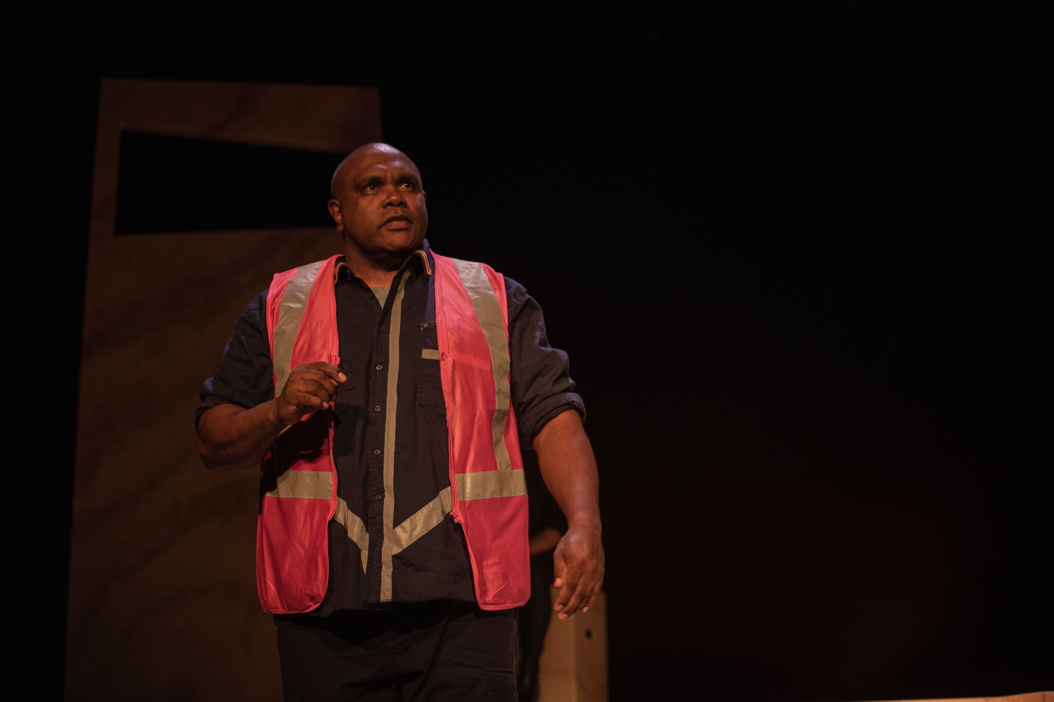Trevor Ryan as Jono wearing a hi-vis vest