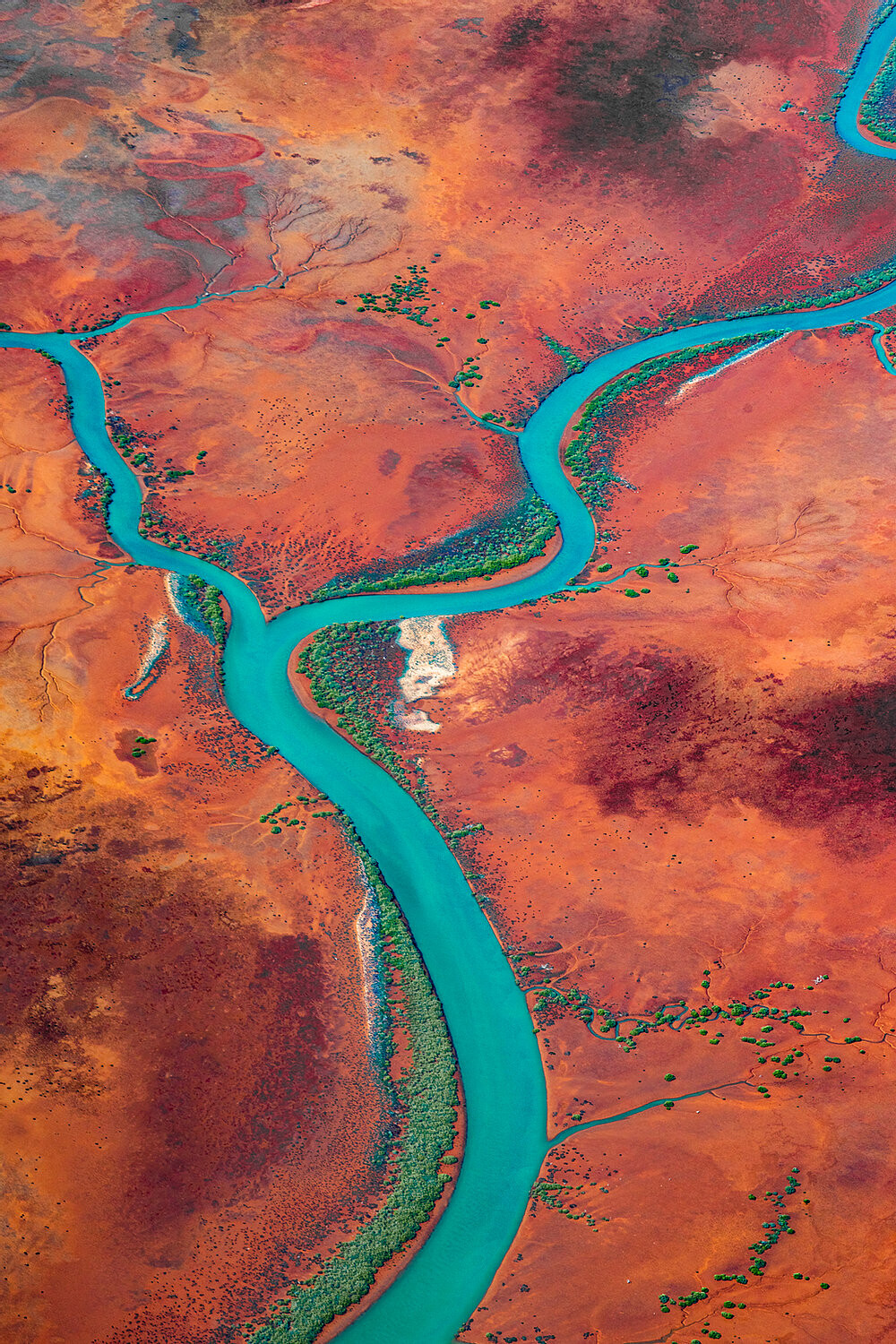Aerial photo of river across red dirt