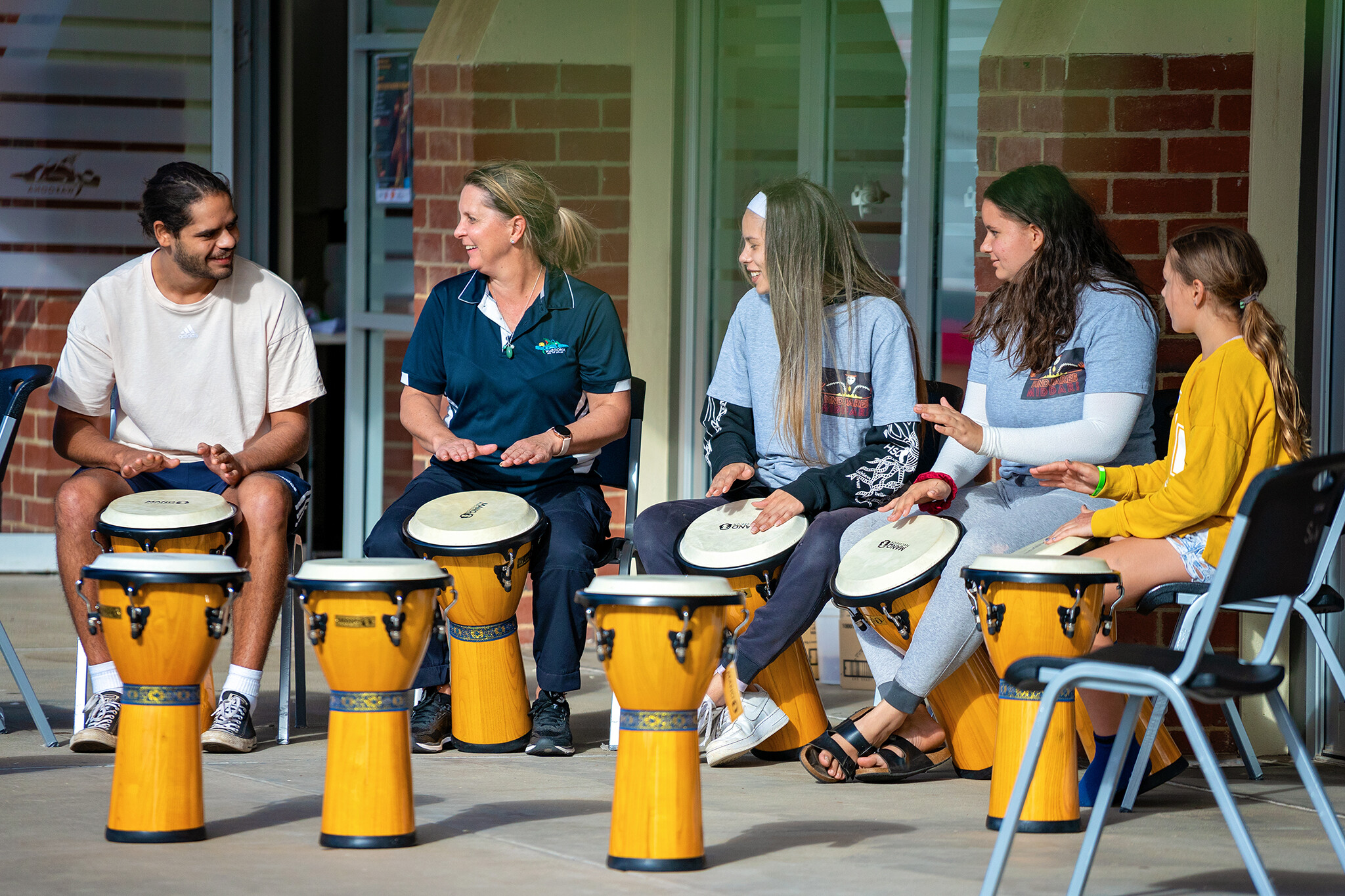 Drug Aware drumming circle with people playing drums.