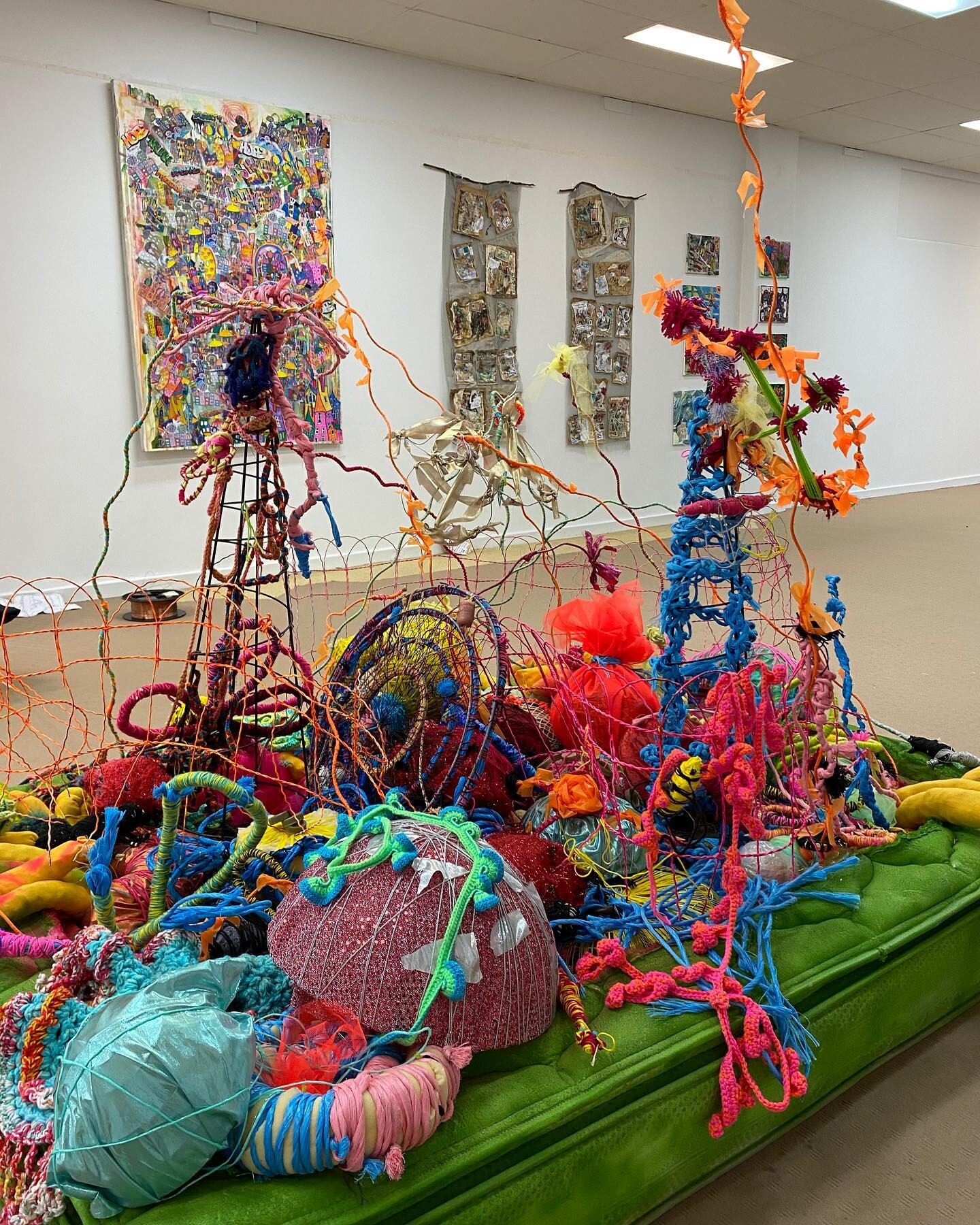 Art piece of an assembly of random objects made from string inside a gallery.