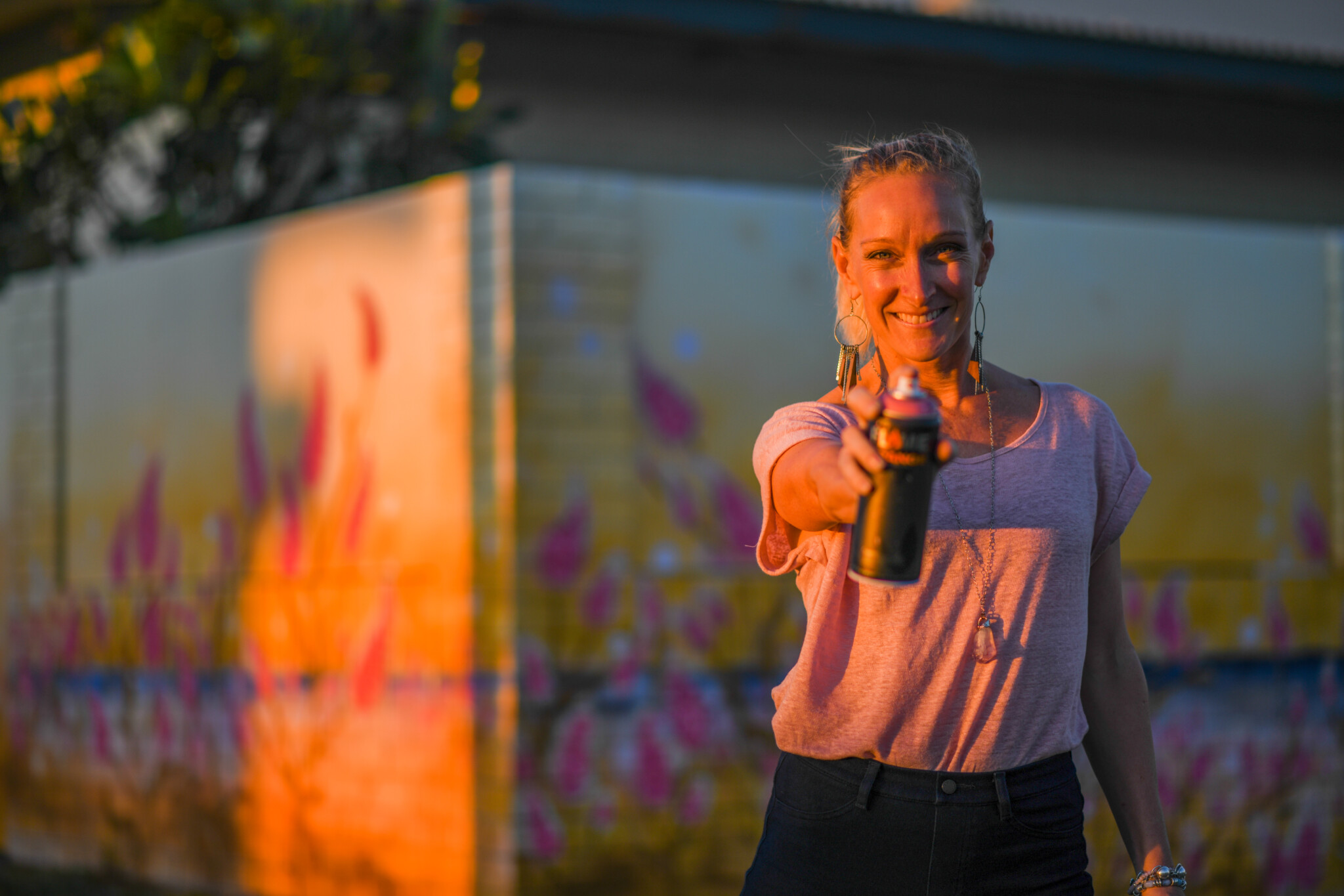 Miranda pointing a spray can at the camera.