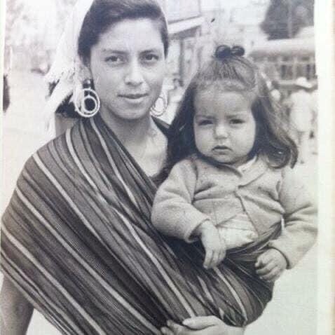Old black and white photo of a woman holding a small female child.