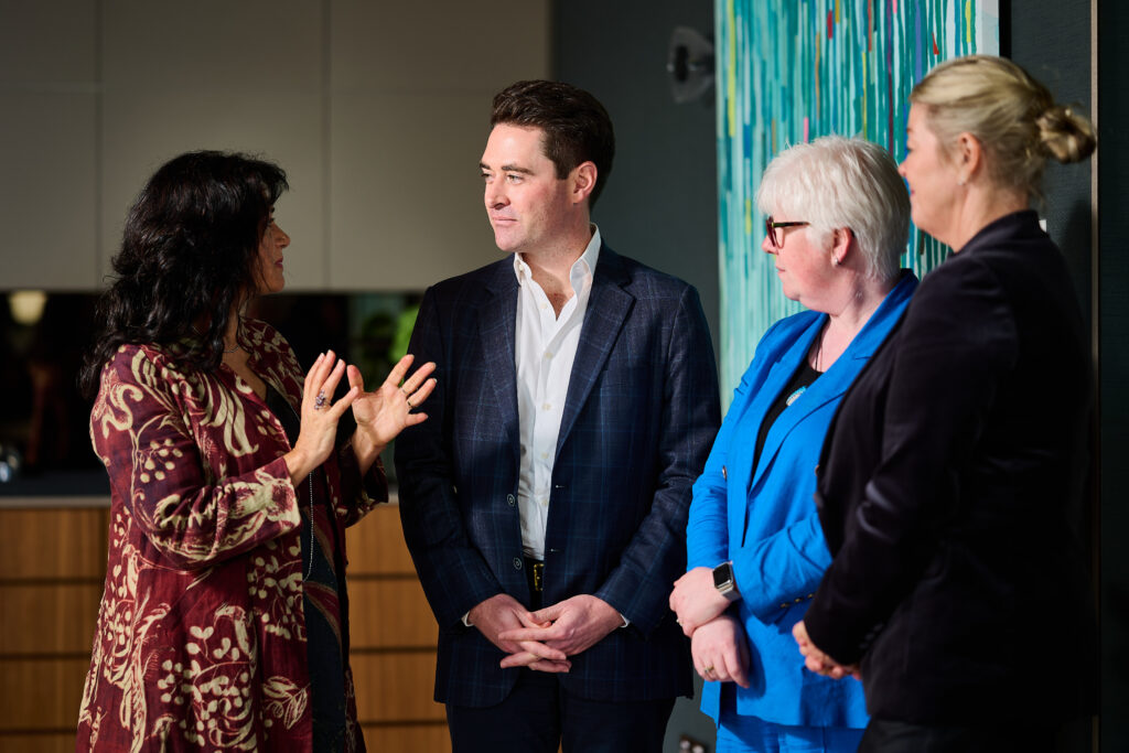 Woman speaking to group of three other people