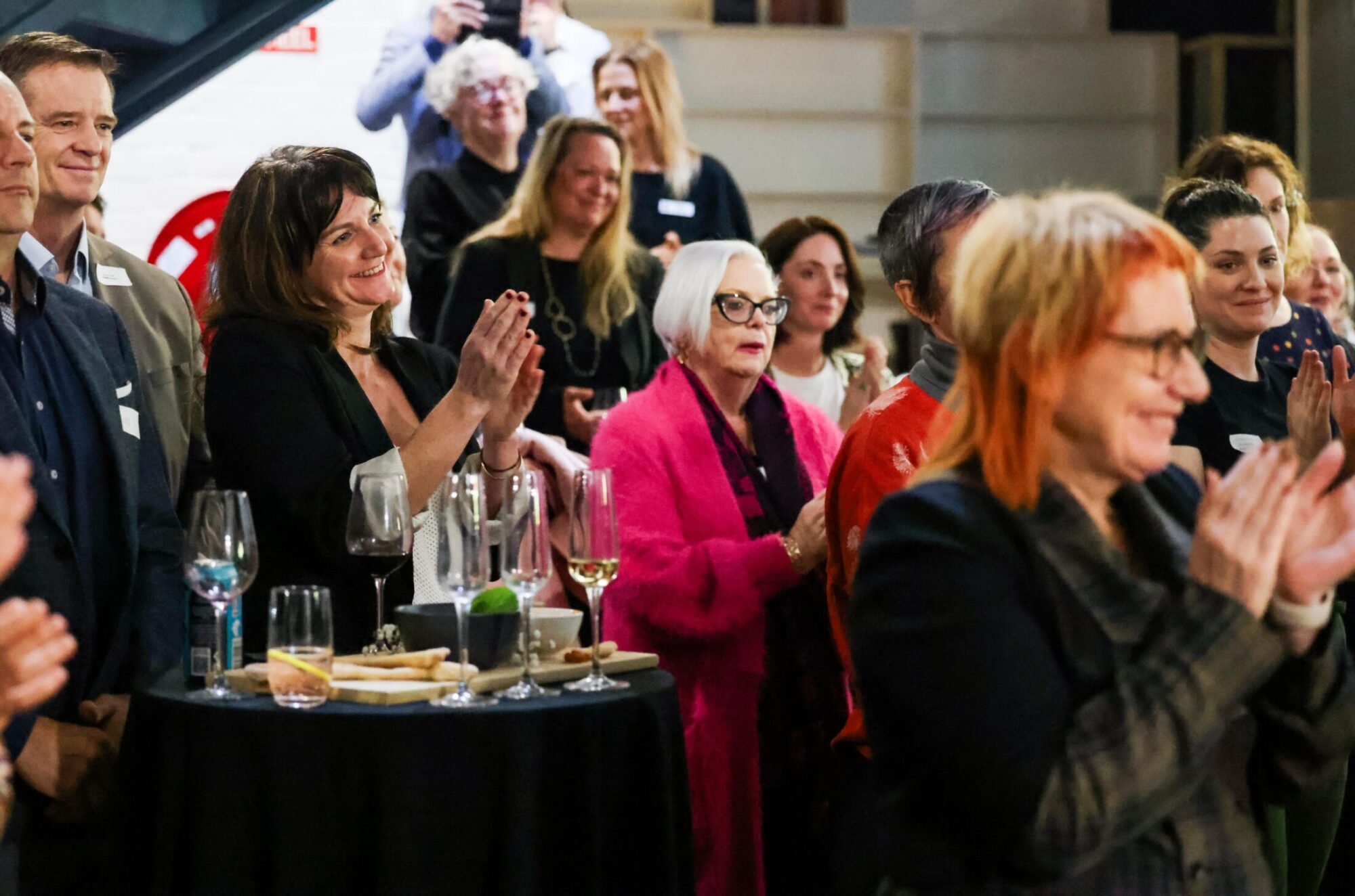 A crowd of people applauding