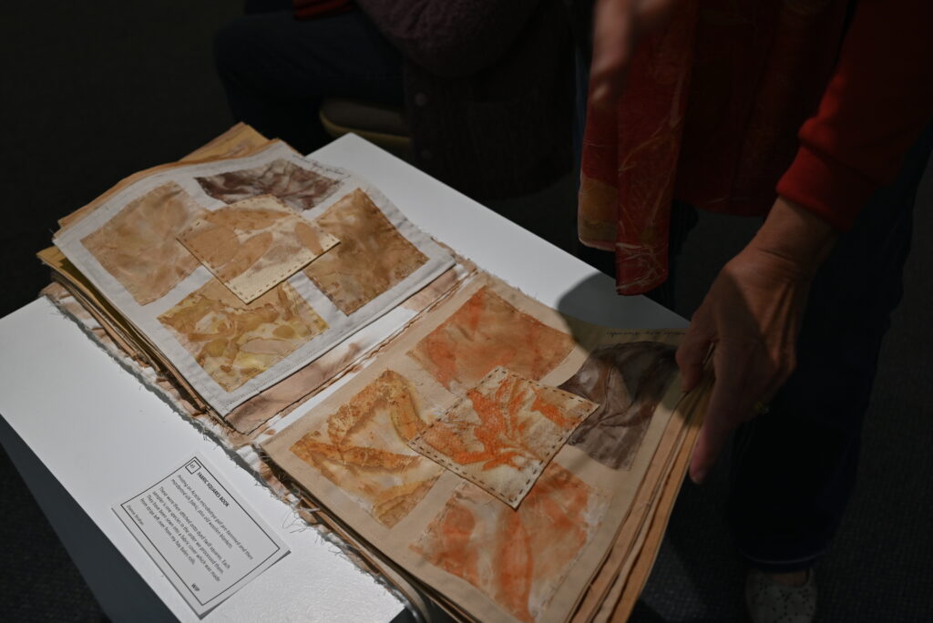 Febric textiles in various earthy-brown colours sewn together to create a book.