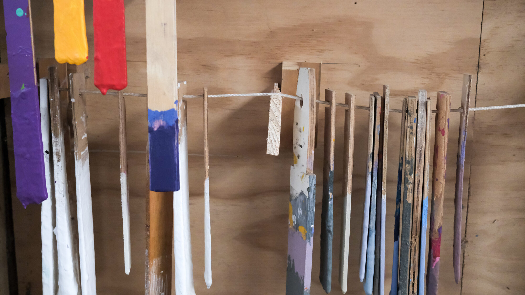 Brushes and painting tools hanging on a wall