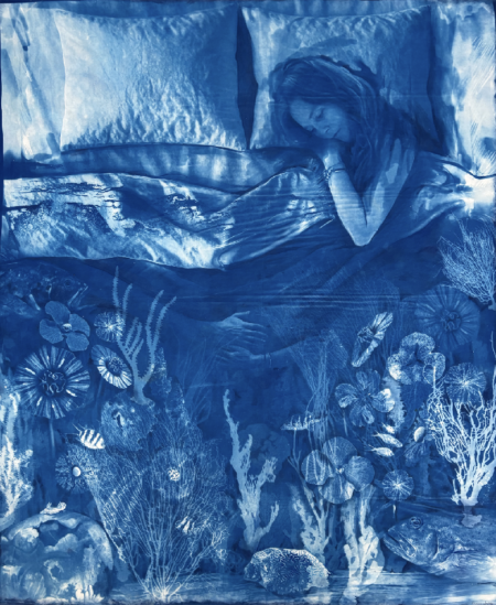 Artwork of a woman in bed. The blanket covering her fades into the image of a coral reef. The artwork is entirely in blue tones.