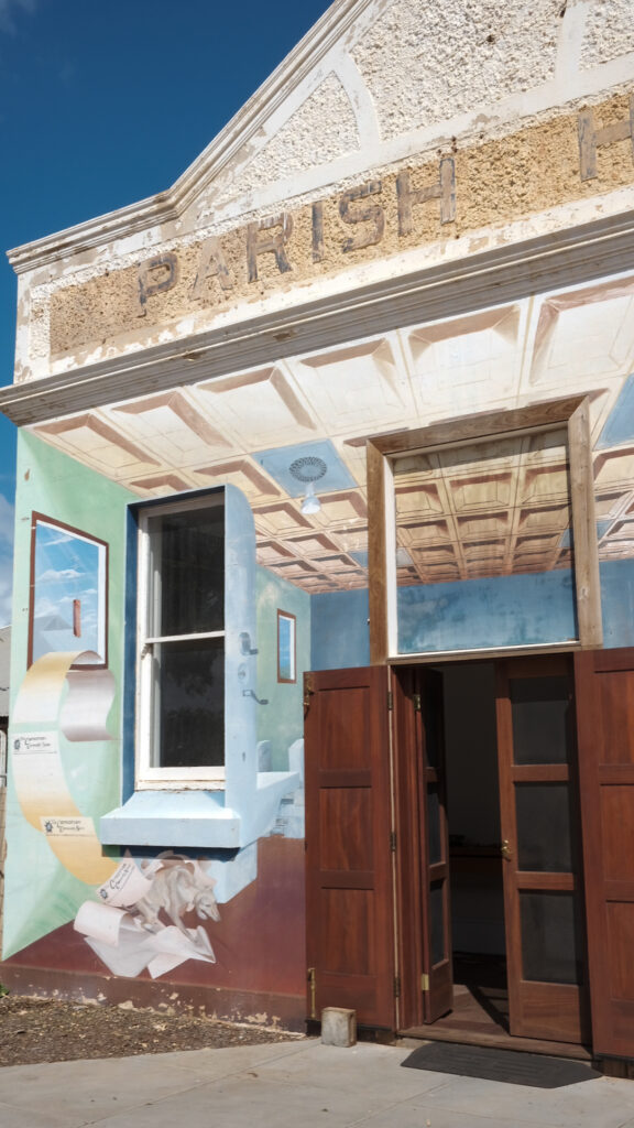 A building facsia painted with the image of the inside of an office.