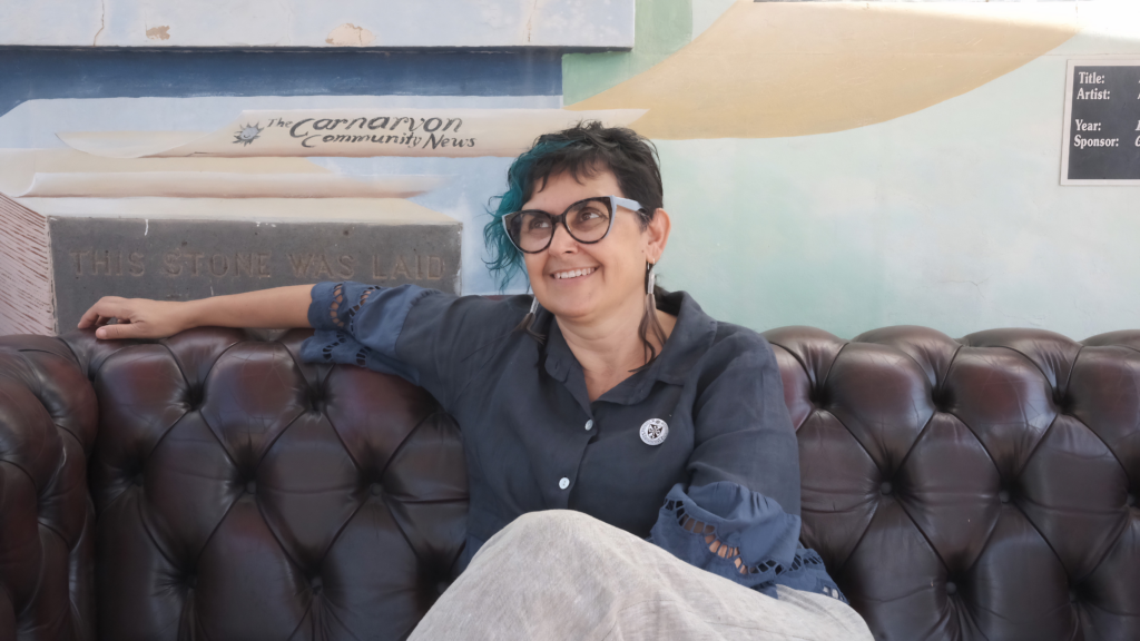 Woman sitting on couch.