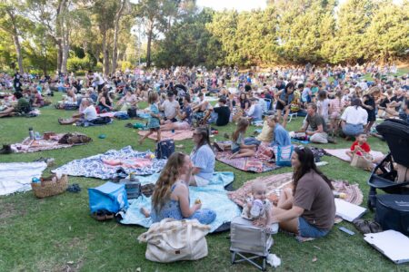 Audience sitting in a park in the daytime