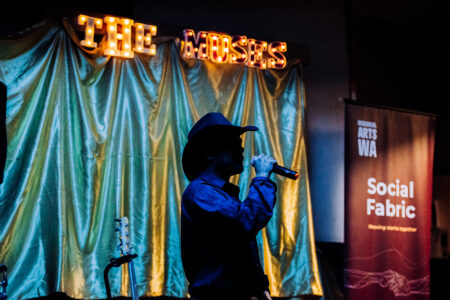 Bailey singing on stage at Night of The Muses in Kalgoorlie