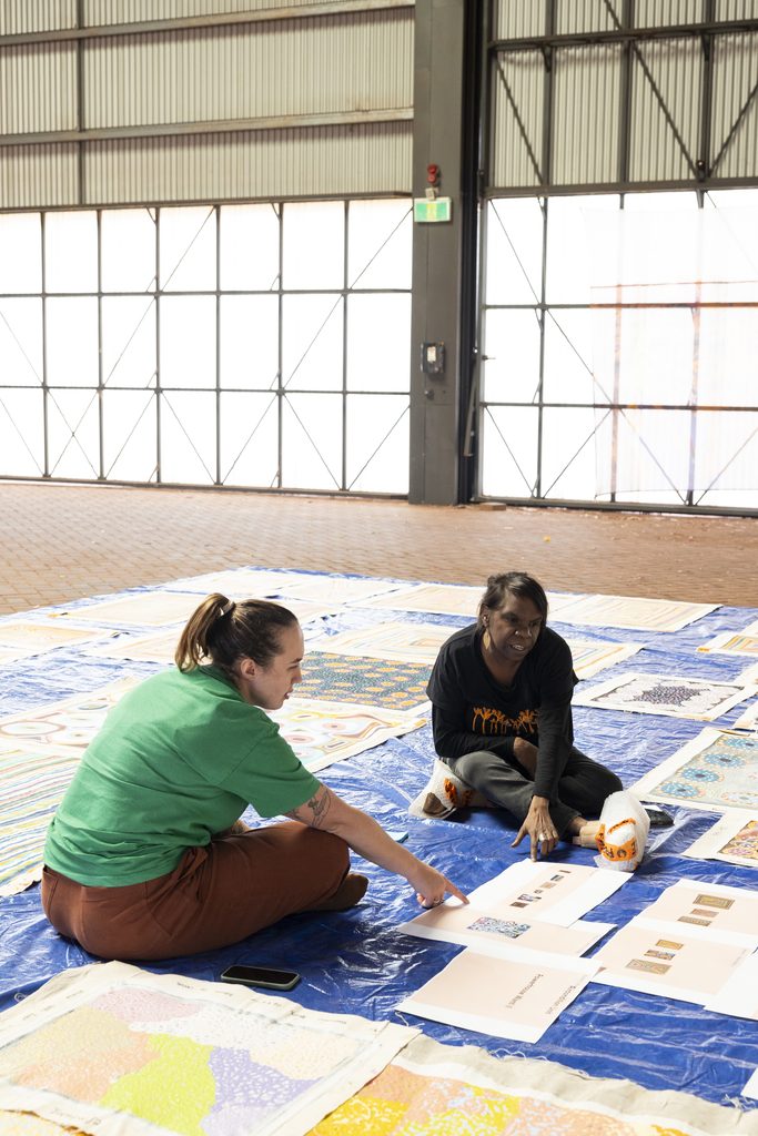 Sylvia Wilson and mentor Zali Morgan during curatorial sessions for Powerhouse Wanti II in Newman, Juyl 2026. Image by Bo Wong, courtesy of Martumili Artists