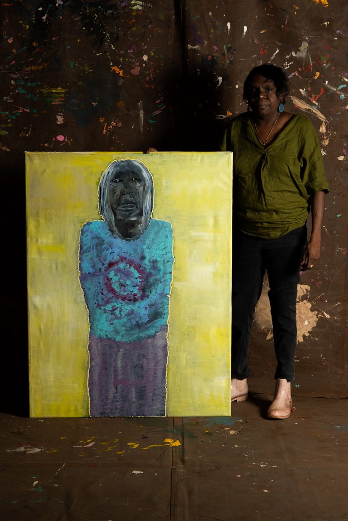 Sylvia Wilson with her painting 'Wanti Yuu', 2025: Photo by Isaac Barber, courtesy of Martumili Artists.