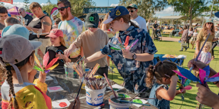 Children doing an arts and crafts activity at an outdoor event.